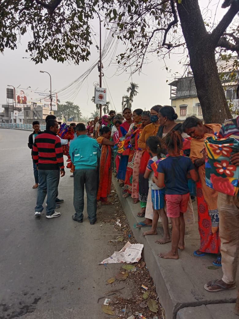 Volunteers meeting families along a roadside during a winter relief drive